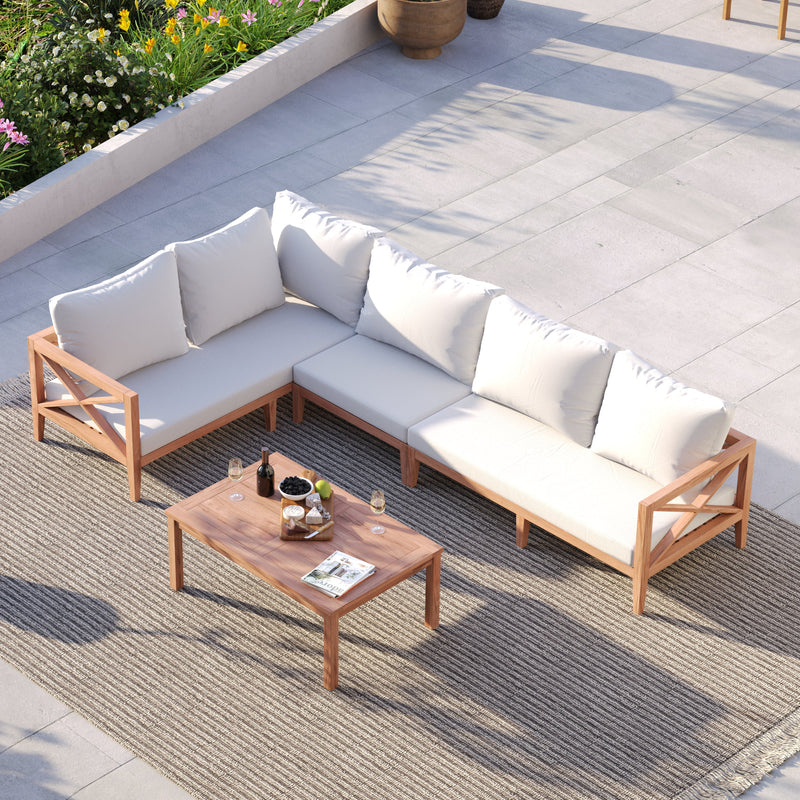 Teak sofa set styled with throws and lanterns on a deck at dusk in winter